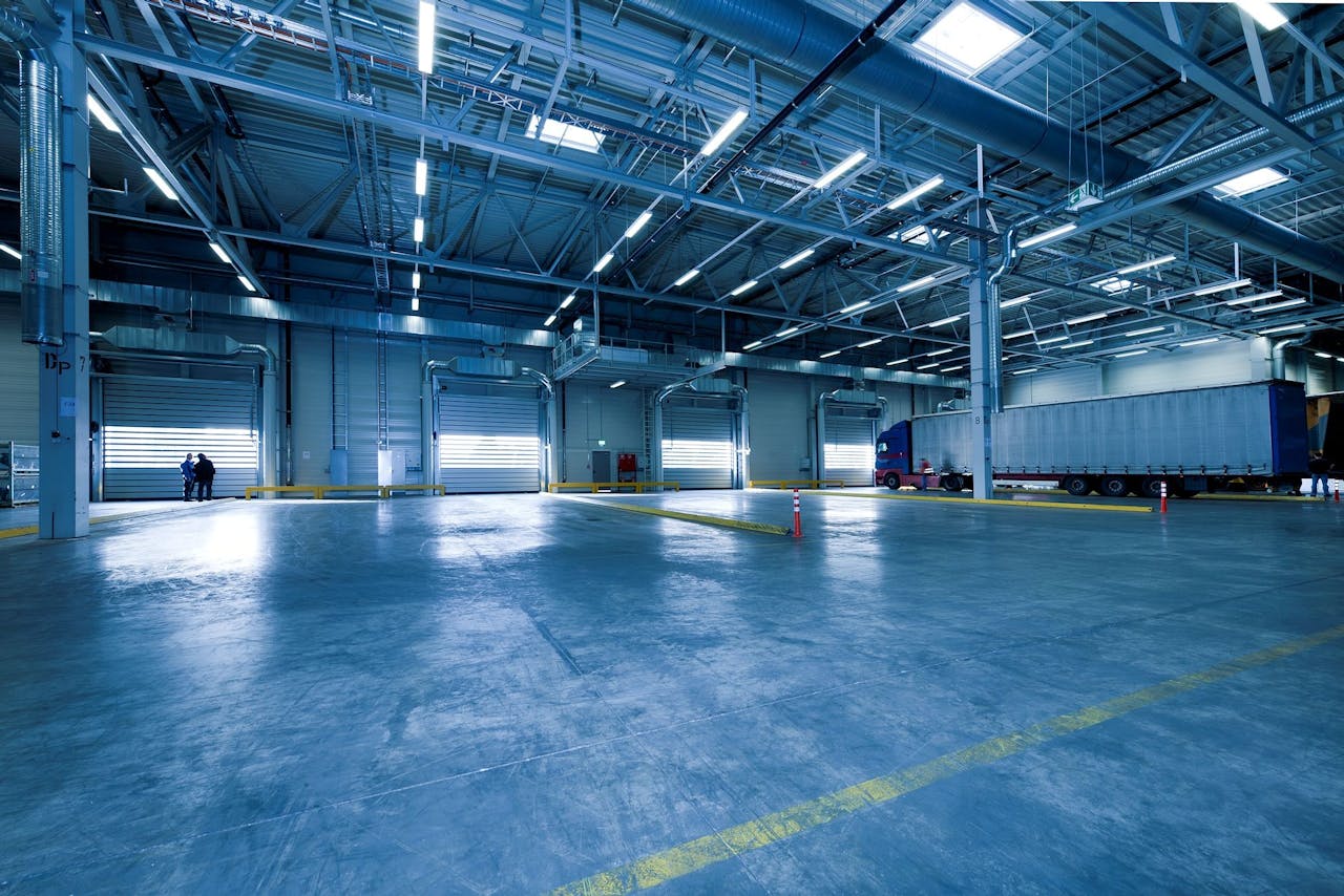services-02 Large warehouse interior with docked truck, ideal for logistics and warehousing.